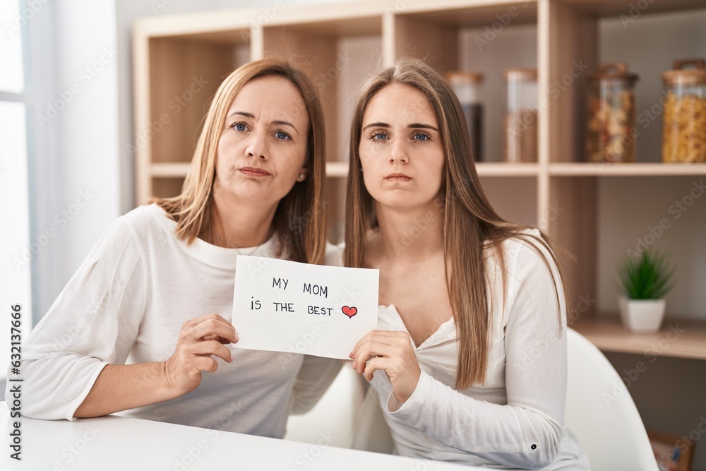 Middle age mother and young daughter holding my mom is the best banner skeptic and nervous, frowning upset because of problem. negative person. Middle age mother and young daughter holding my mom is the best banner skeptic and nervous, frowning upset because of problem. negative person.