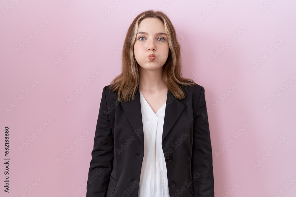 Young caucasian business woman wearing black jacket puffing cheeks with funny face. mouth inflated with air, crazy expression. - obrazy, fototapety, plakaty 