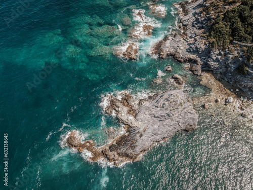 Drone top down aerial view of a beach with clear sea water and rocks at Mylopotamos Greece summer_1