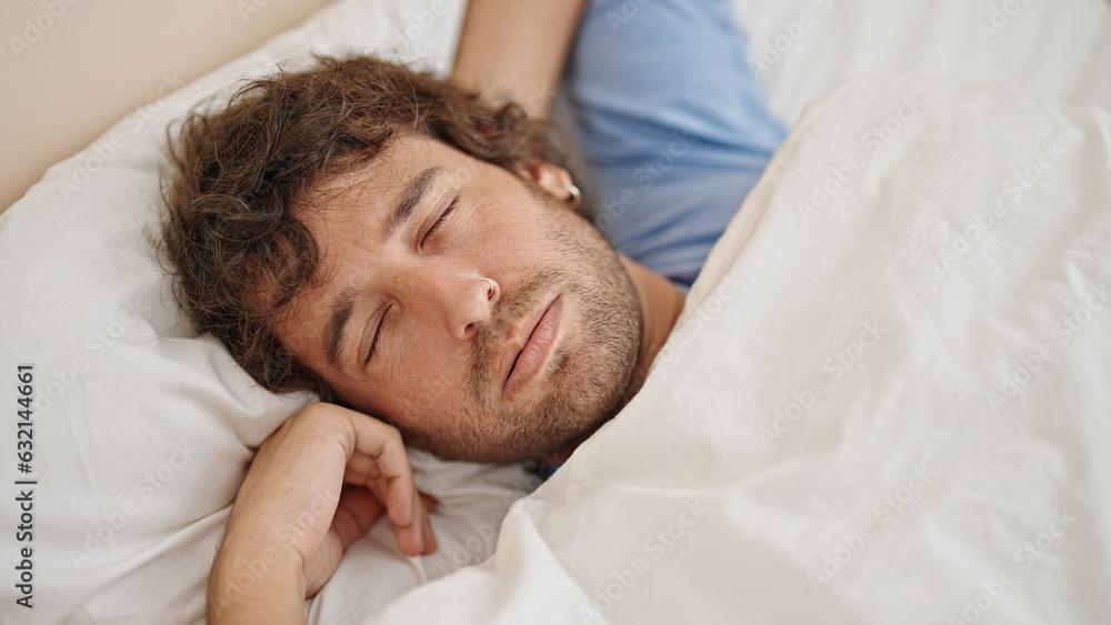 Young hispanic man lying on bed sleeping at bedroom Young hispanic man lying on bed sleeping at bedroom