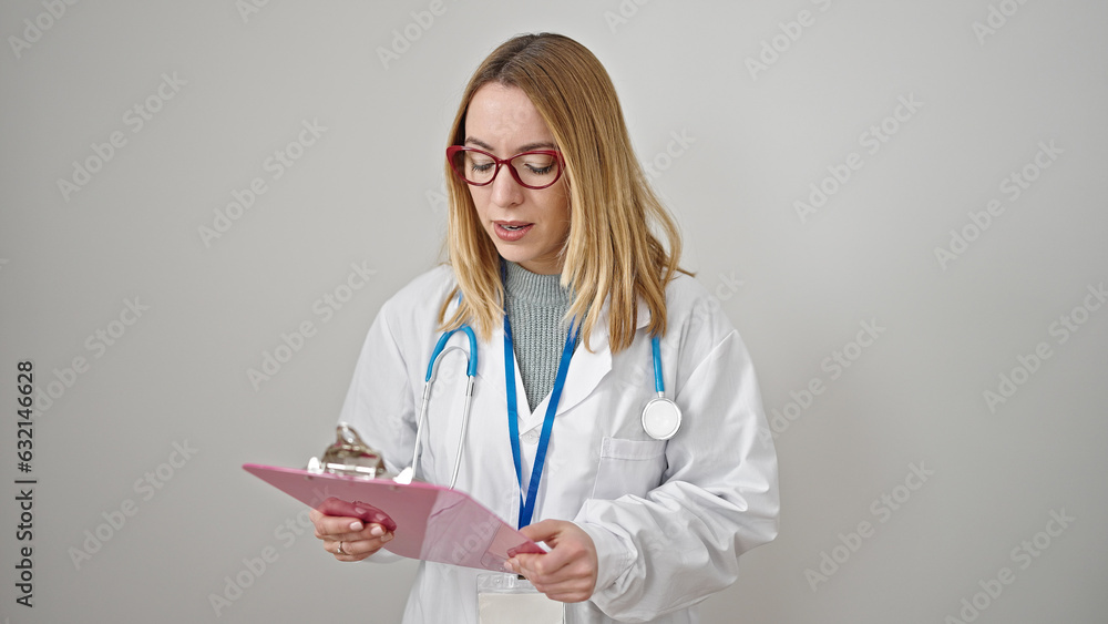 Young blonde woman doctor reading document on clipboard over isolated white background Young blonde woman doctor reading document on clipboard over isolated white background