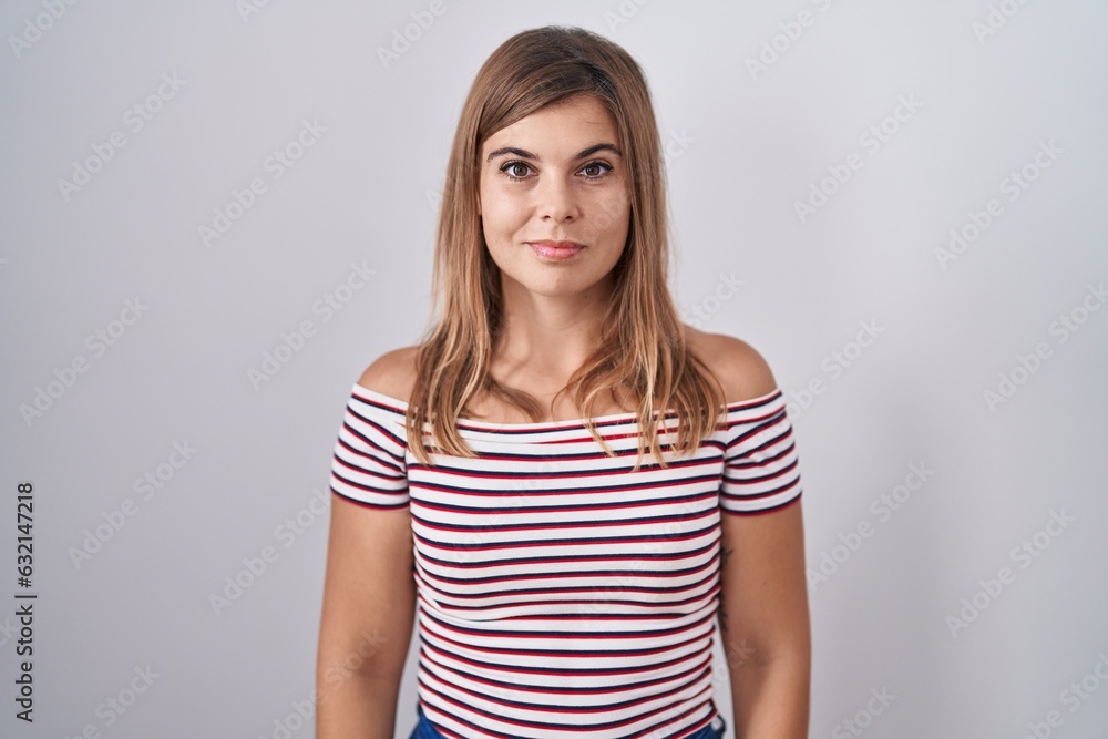 Young hispanic woman standing over isolated background relaxed with serious expression on face. simple and natural looking at the camera. Young hispanic woman standing over isolated background relaxed with serious expression on face. simple and natural looking at the camera.
