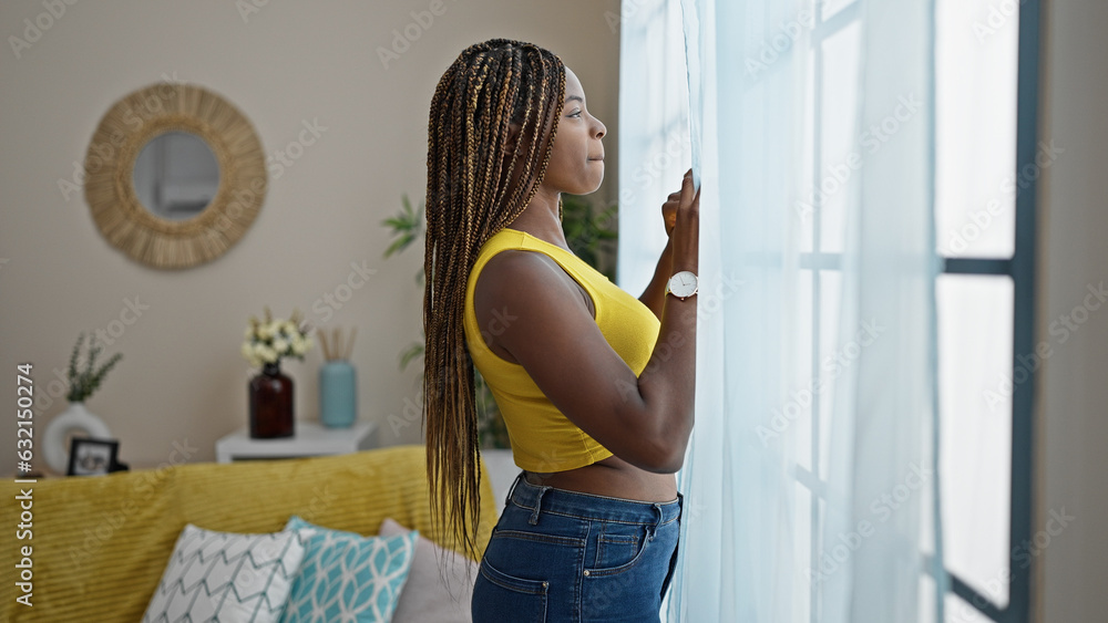 African american woman looking throw the window at home African american woman looking throw the window at home