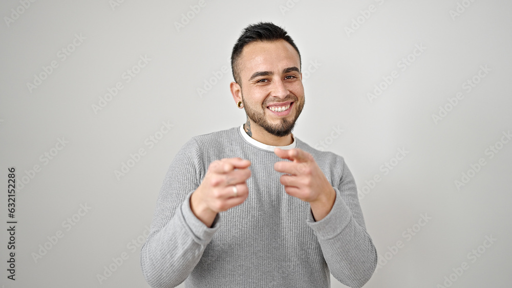 Hispanic man smiling confident pointing with fingers to the camera over isolated white background Hispanic man smiling confident pointing with fingers to the camera over isolated white background