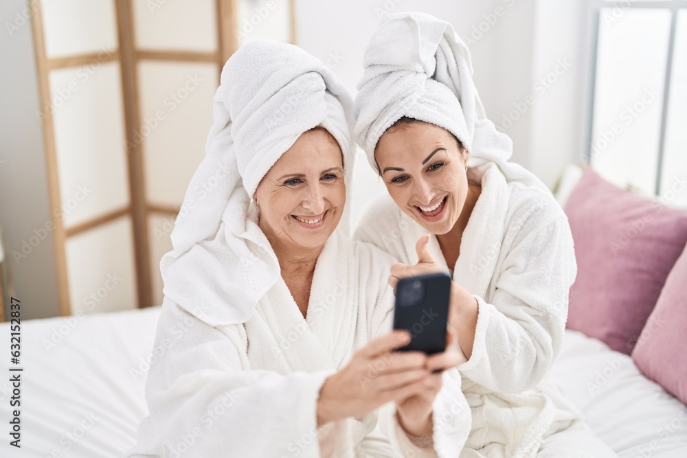 Mother and daughter wearing bathrobe having video call at bedroom Mother and daughter wearing bathrobe having video call at bedroom