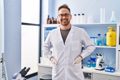 Young caucasian man scientist smiling confident standing at laboratory