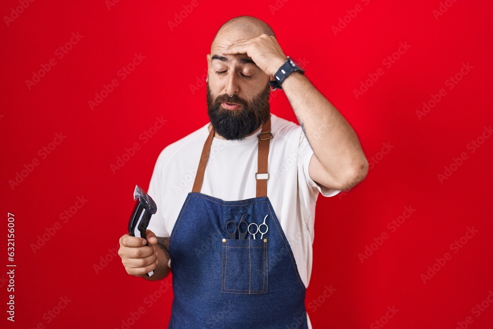 Young hispanic man with beard and tattoos wearing barber apron holding razor worried and stressed about a problem with hand on forehead, nervous and anxious for crisis Young hispanic man with beard and tattoos wearing barber apron holding razor worried and stressed about a problem with hand on forehead, nervous and anxious for crisis