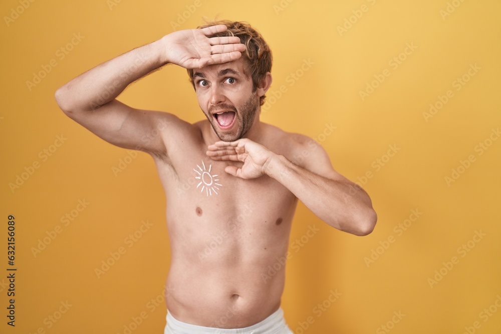 Caucasian man standing shirtless wearing sun screen smiling cheerful playing peek a boo with hands showing face. surprised and exited