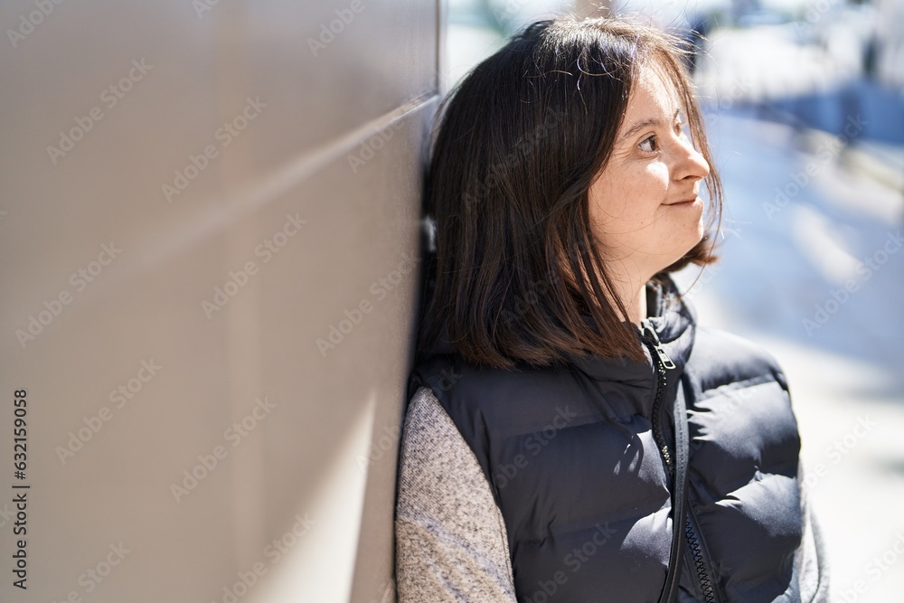 Young woman with down syndrome smiling confident looking to the side at street Young woman with down syndrome smiling confident looking to the side at street