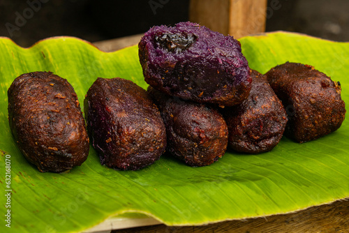 timus is a sweet-tasting food made from mashed sweet potatoes and filled with various sweet fillings. timus on a banana leaf photo