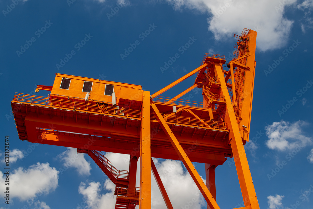 a big orange crane on blue sky