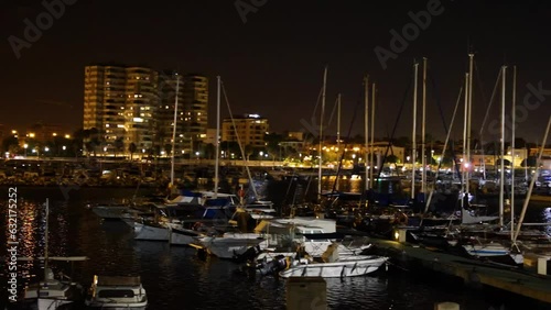 Wallpaper Mural 4K video of boats docked at sea at night with city lights, urban skyline and glowing reflections on the water Torontodigital.ca