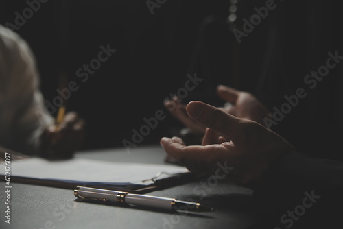 .Business and lawyers discussing contract papers with brass scale on desk in office. Law, legal services, advice, justice and law concept picture with film grain effect