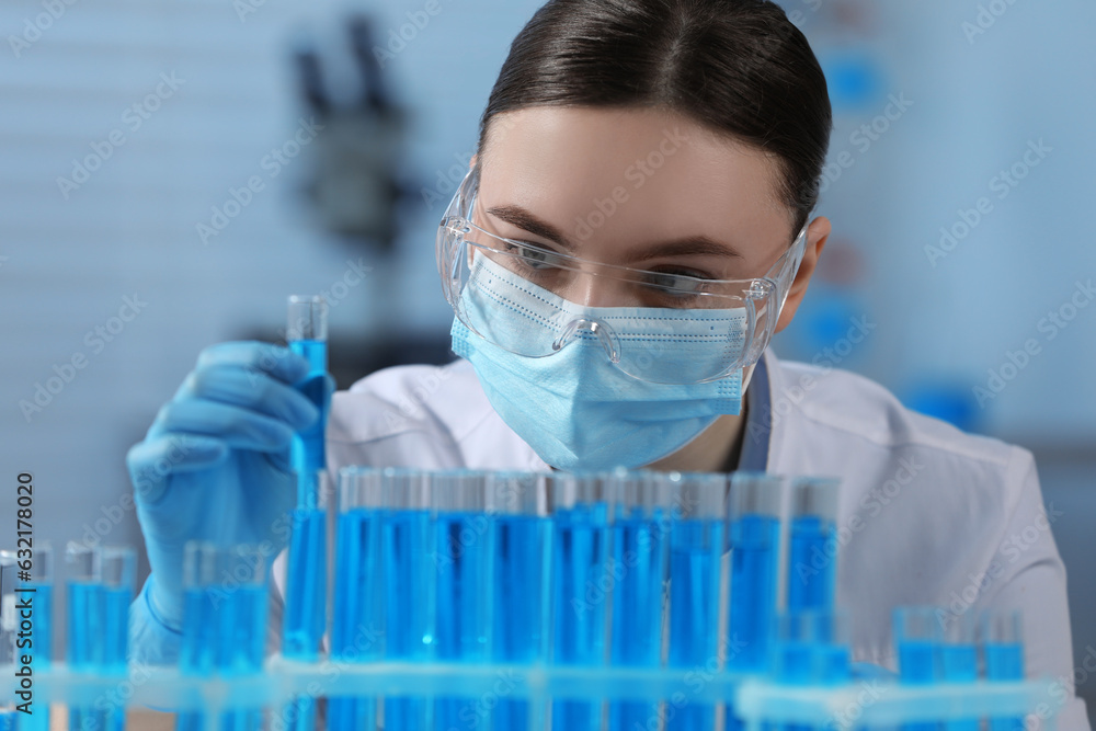 Fototapeta premium Scientist holding test tube with sample in laboratory