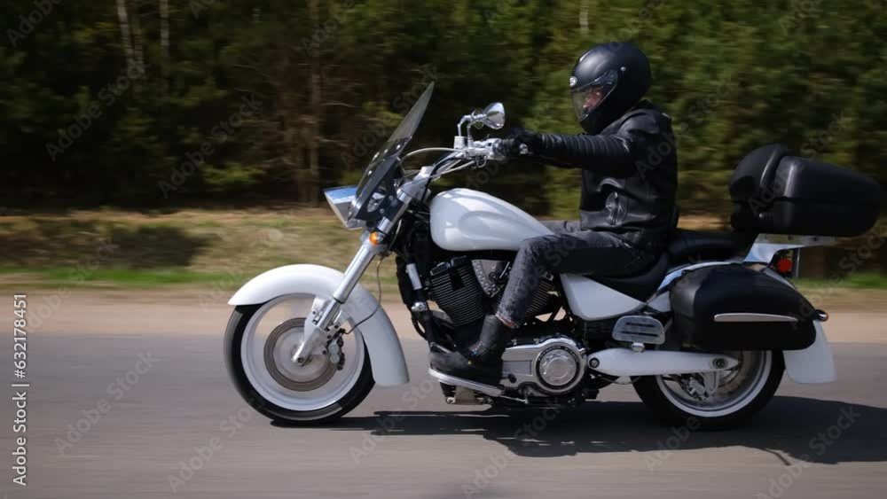 a man in black riding a white motorcycle a man in black riding a white motorcycle
