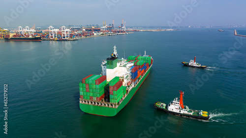  rear view of cargo container ship and tugboat sailing in sea and commercial port background to import export goods and distributing products to dealer and consumers worldwide, by container ship t  photo