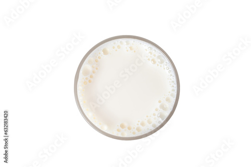 "Milk in a glass with frothy foam at the top, standing tall against the white background."