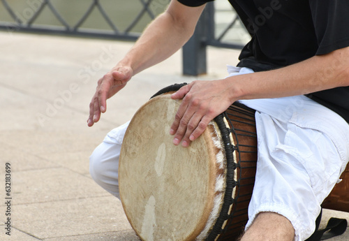 A man plays the djembe drum on a street in Moscow, Russia