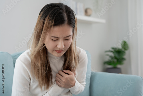 Free Download hand hold chest with heart attack symptoms, asian woman have chest pain caused by heart disease, leak, dilatation, enlarged coronary heart, press on the chest with a painful expression - GFXLoad