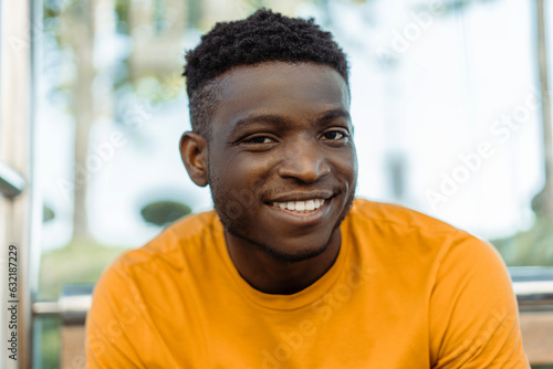 Authentic portrait of handsome smiling African American man looking at camera