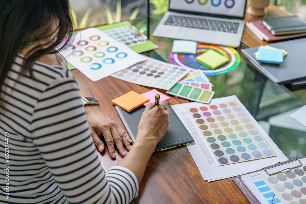 Teamwork brainstorming Creative idea Business project. Business People meeting taking notes while discussing with Color swatch samples to share idea Teamwork brainstorming Creative idea Business project. Business People meeting taking notes while discussing with Color swatch samples to share idea