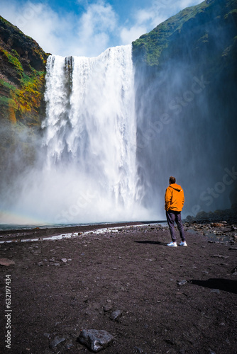 Man Looking at Iceland Waterfall