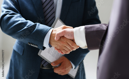 Man in suit shake hand as hello in office closeup. Friend welcome mediation offer positive introduction greet or thanks gesture summit participate approval background strike arm bargain concept