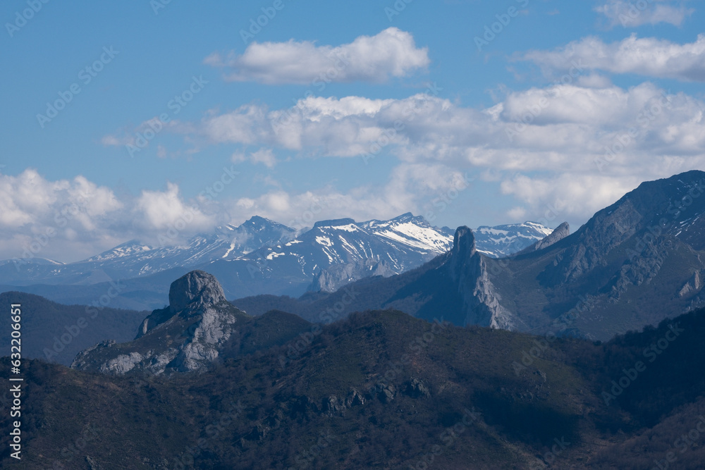 Rock formation with high peaks with snow on the background