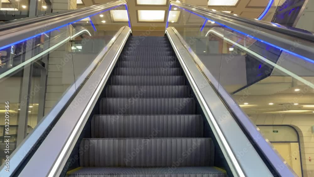 Escalators in modern shopping mall crowd of people. Many people move on escalators in floors shopping center Escalators in modern shopping mall crowd of people. Many people move on escalators in floors shopping center