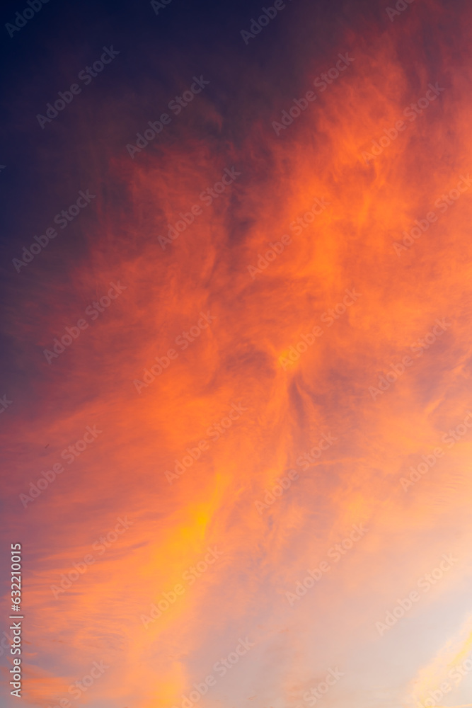 Dramatic sunset sky clouds Vertical in the Evening on twilight with Red, Orange, Yellow sunlight Dramatic sunset sky clouds Vertical in the Evening on twilight with Red, Orange, Yellow sunlight