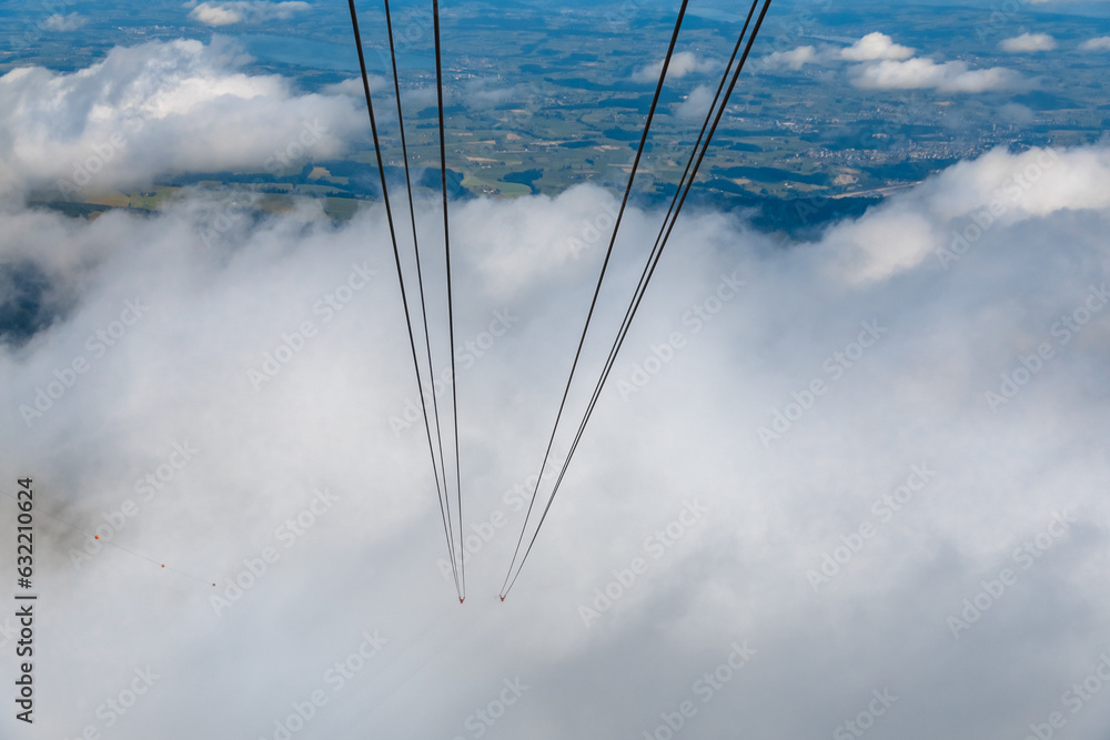 Φωτογραφία The modern Dragon Ride aerial cableway hidden in the clouds while slowly ascending to the famous Pilatus Kulm mountain station