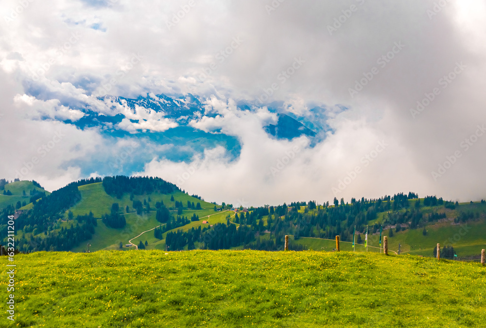 Fototapeta premium Lovely landscape view of the Rigi Kulm's surrounding with the alps in the background. Geologically, the Rigi is not part of the Alps, but instead belongs to the Swiss plateau.