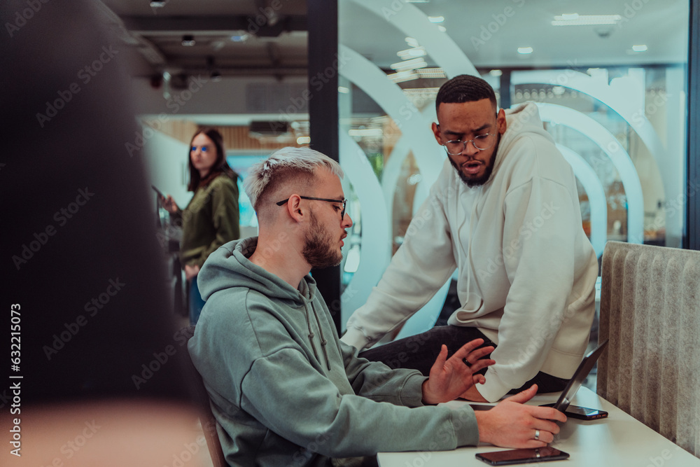 Obraz premium Young group of business people brainstorming together in a startup space, discussing business projects, investments, and solving challenges.