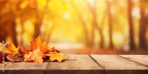 Beautiful colorful natural autumn background for presentation. Fallen dry orange leaves on wooden boards against the backdrop of a blurry autumn park