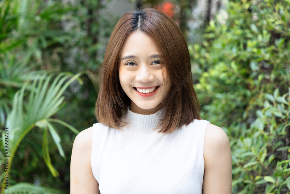 Happy Smiling Relaxed young woman in green urban park environment Happy Smiling Relaxed young woman in green urban park environment