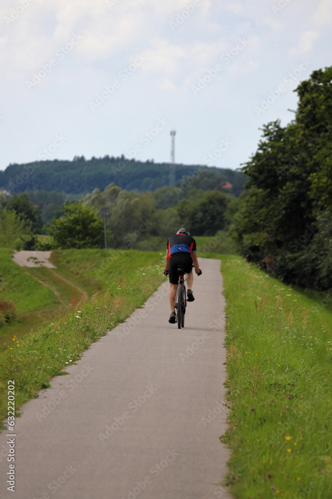 Cyclists on a bike path near Tyniec, Poland. Actively spending time outdoors