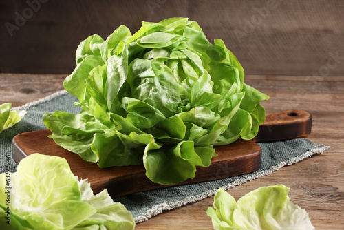 Fresh green butter lettuce on wooden table, closeup