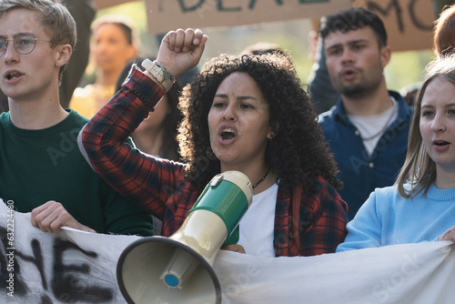 Konstfotografi Student Activist Leading Protest with Megaphone - A close-up of a young curly-ha