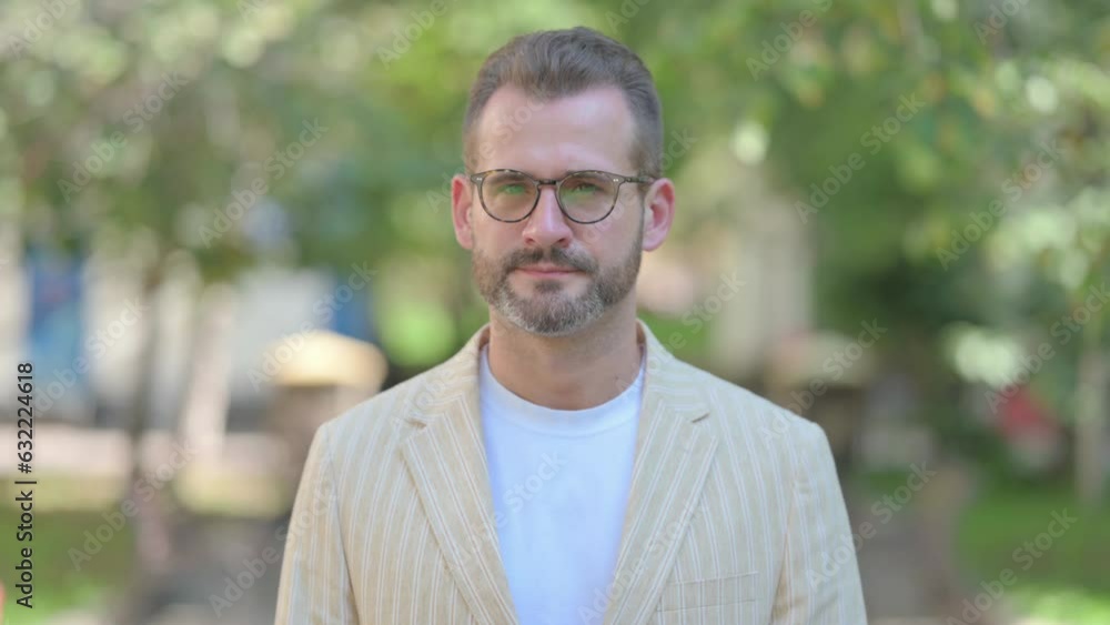 Outdoor Portrait of Middle Aged Man Shaking Head in Denial Outdoor Portrait of Middle Aged Man Shaking Head in Denial