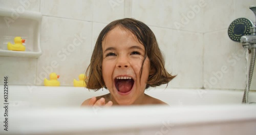 Soaked in Joy: Immersing in the Wonder and Delight of a Child's Bathing Experience. High quality 4k footage
