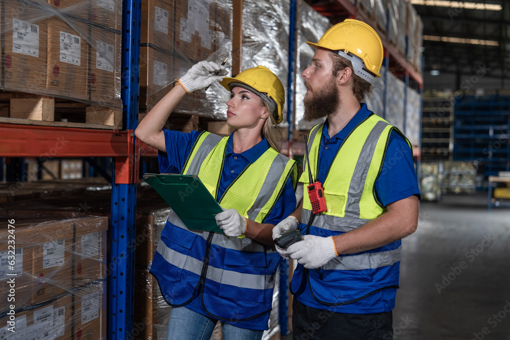 Foreman Caucasian foreman and female worker in uniform and helmet