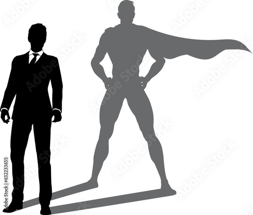 A superhero business man revealed by his shadow silhouette as a super hero in a cape
