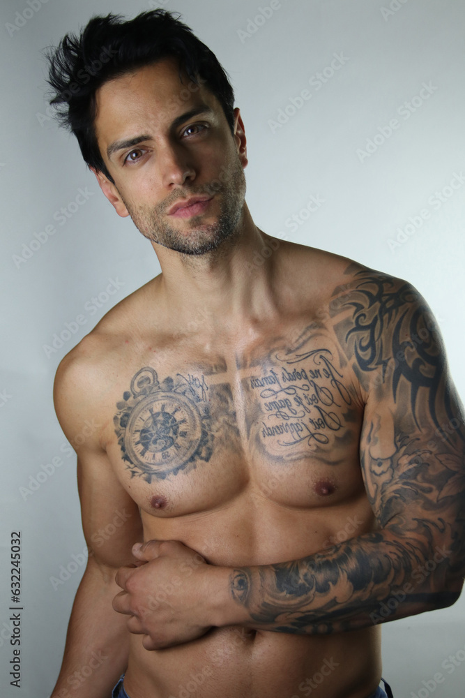 Fototapeta premium Sexy portrait of a handsome muscular topless male model on white background