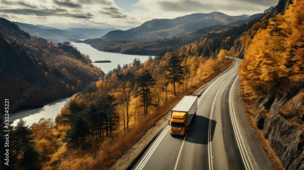 Aerial view of truck on the road in autumn highway.