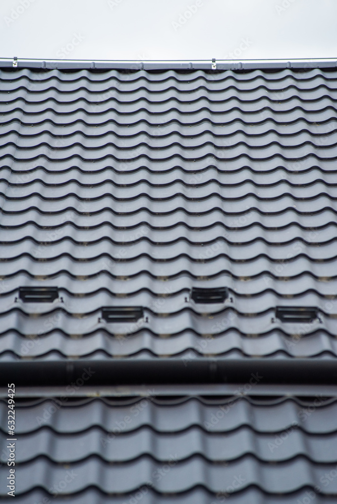Modern building. Roof tiles on a roof Modern building. Roof tiles on a roof