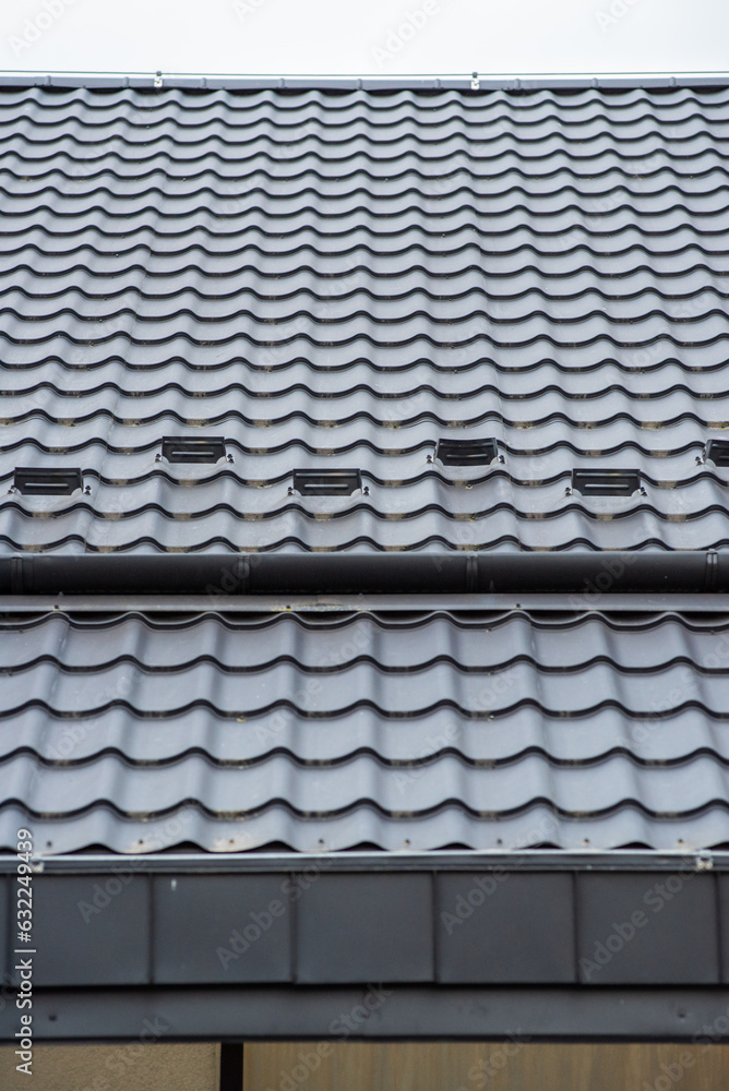 Modern building. Roof tiles on a roof Modern building. Roof tiles on a roof