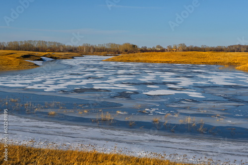 Fototapeta Naklejka Na Ścianę i Meble -  Russia, South of Western Siberia. Spring view of the last ice on the small flat rivers of Kuzbass.