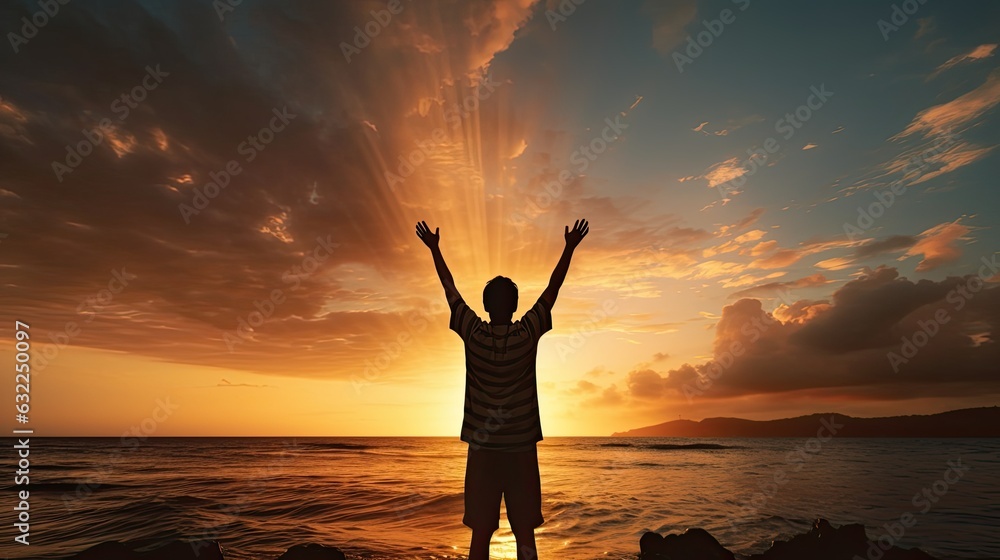 Boy s silhouette in sunset over sea representing religion worship prayer and praise