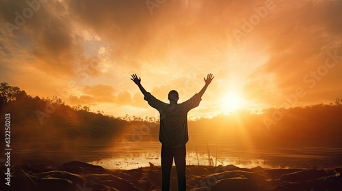 Fotografiet Man s silhouette with raised hands against sunset representing religion faith an