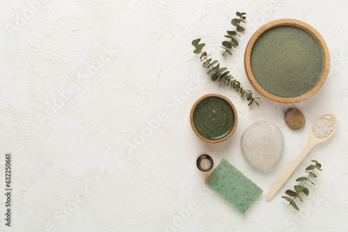 Composition with cosmetic clay and spa products on concrete background, top view